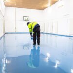 Worker applying polyurethane flooring