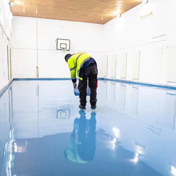 Worker applying polyurethane flooring