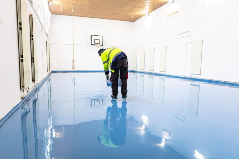 Worker applying polyurethane flooring