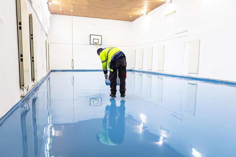 Worker applying polyurethane flooring
