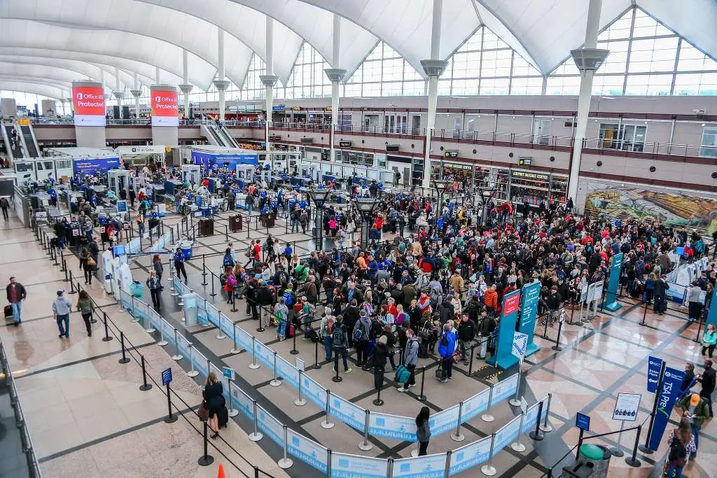 Travelers waiting in line at security checkpoint at Denver International Airport