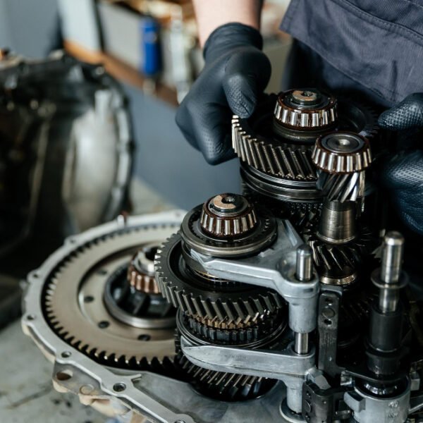 A disassembled gearbox in the hands of an car mechanic