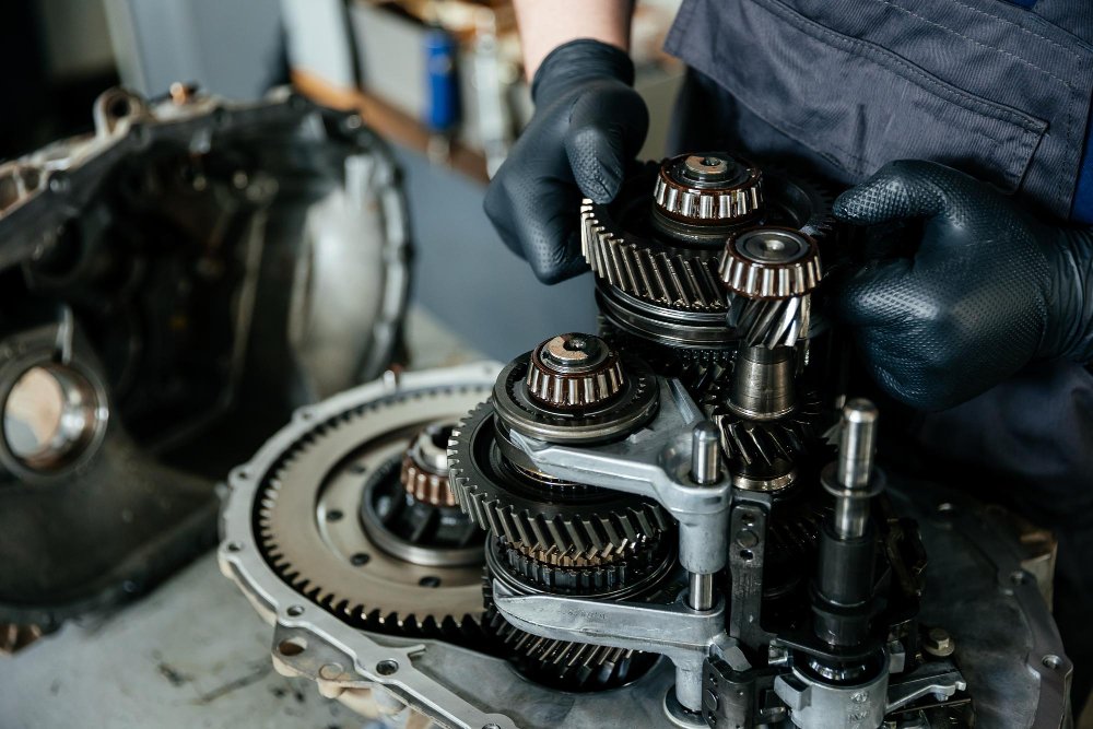 A disassembled gearbox in the hands of an car mechanic