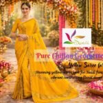 Beautiful woman wearing yellow saree in haldi function with contrasting pink and floral decoration