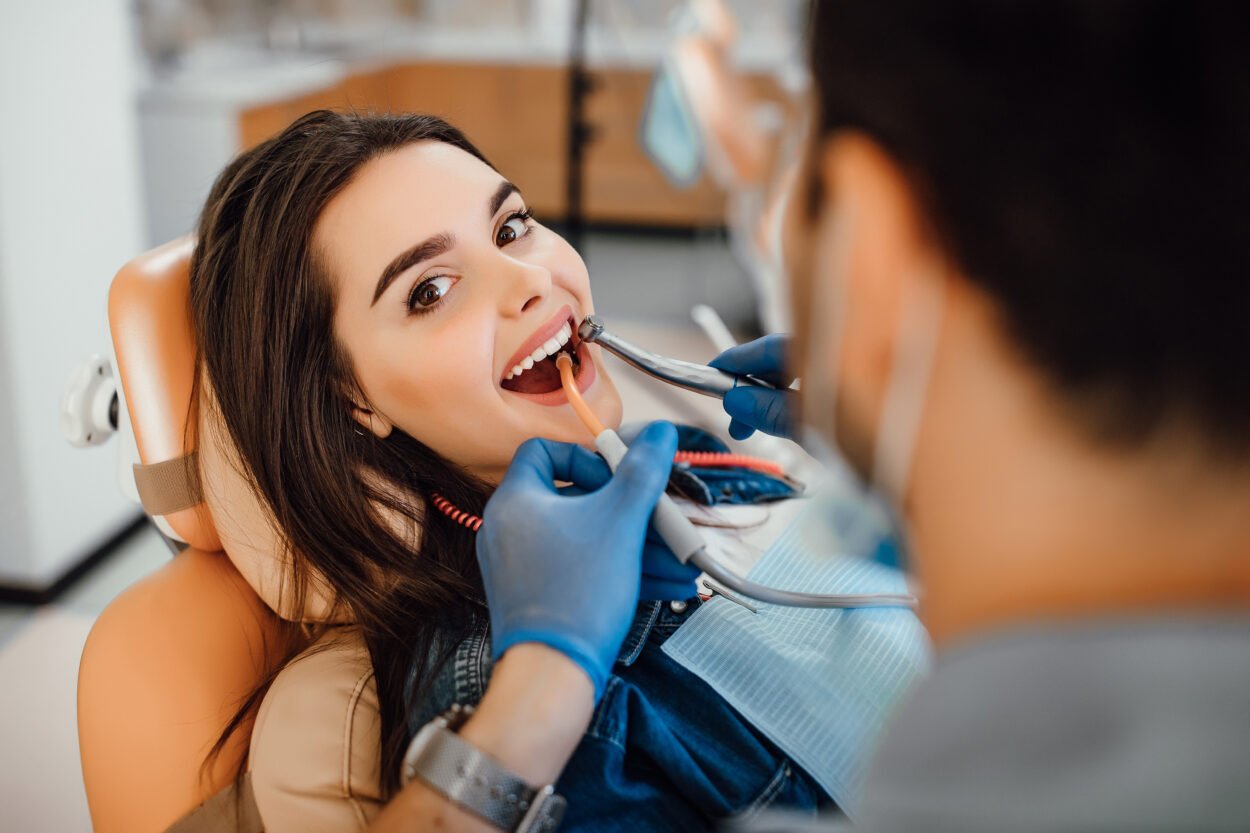 Young woman smiling at dentist's office.
