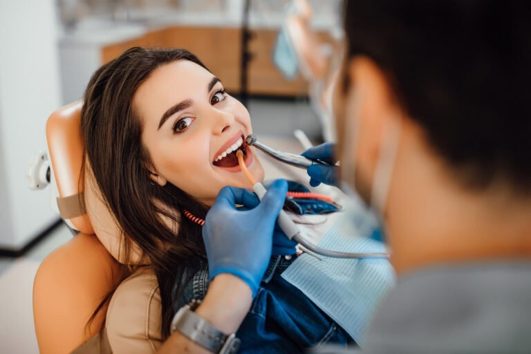 Young woman smiling at dentist's office.